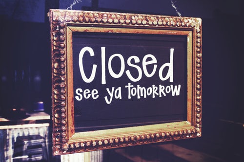 Shop sign on local community business reading "closed see ya tomorrow"